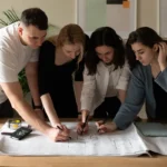 Design team reviewing residential floor plans and coordinating layout decisions