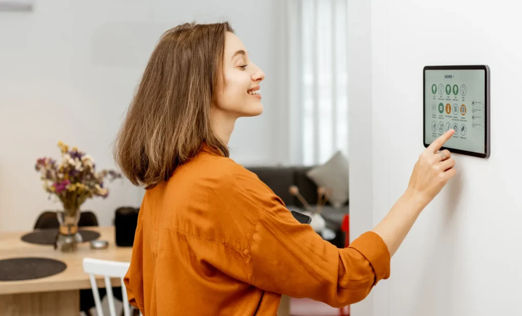 Woman adjusting smart home control panel in modern California house
