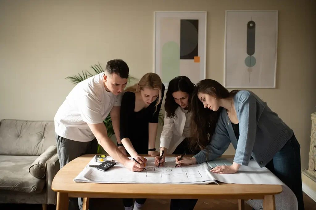 Architects and clients working together on custom home design plans