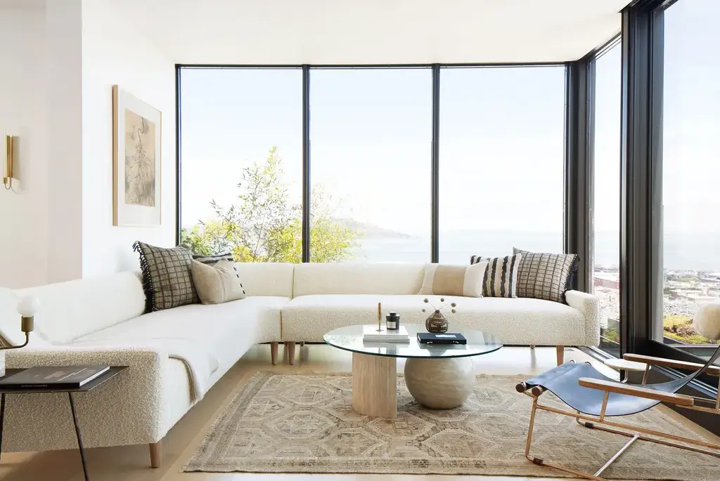 Natural light as a design element in a modern living space with large windows