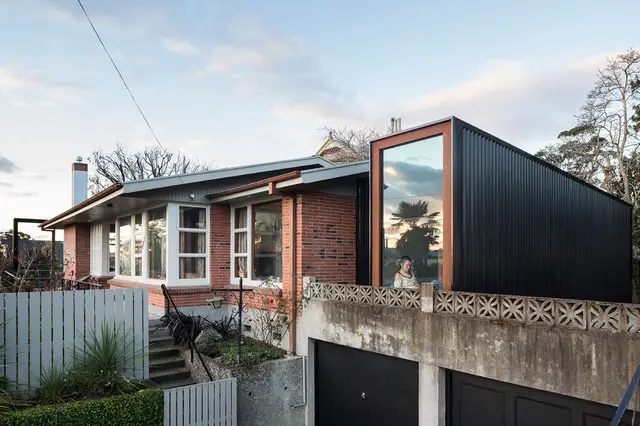 modern house extension with black exterior added to brick home