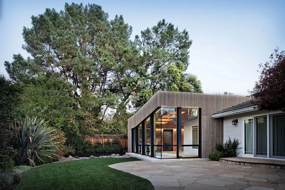 modern room addition with glass walls and wood exterior