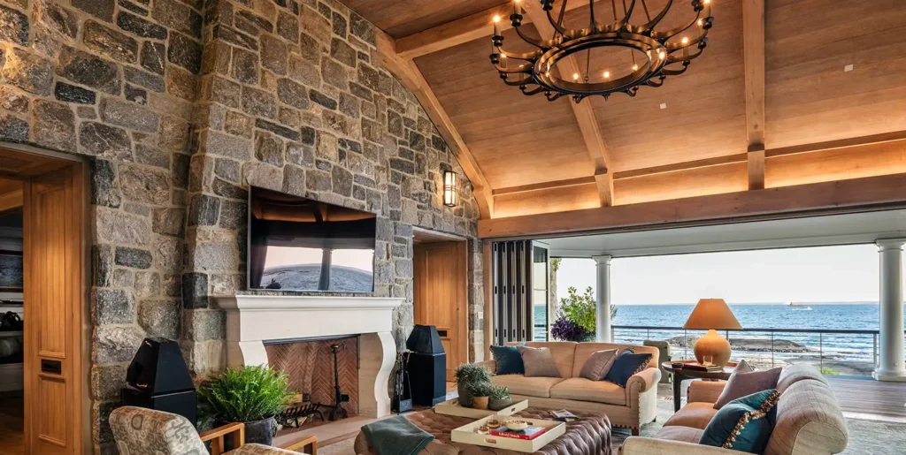 Custom home interior with natural stone wall, wood ceiling, and high-end finishes