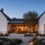 Custom home exterior at dusk with open indoor-outdoor living space, California