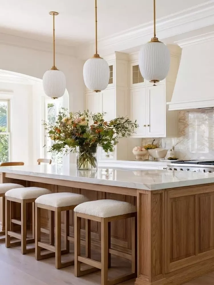 Bright kitchen with wood island and pendant lighting