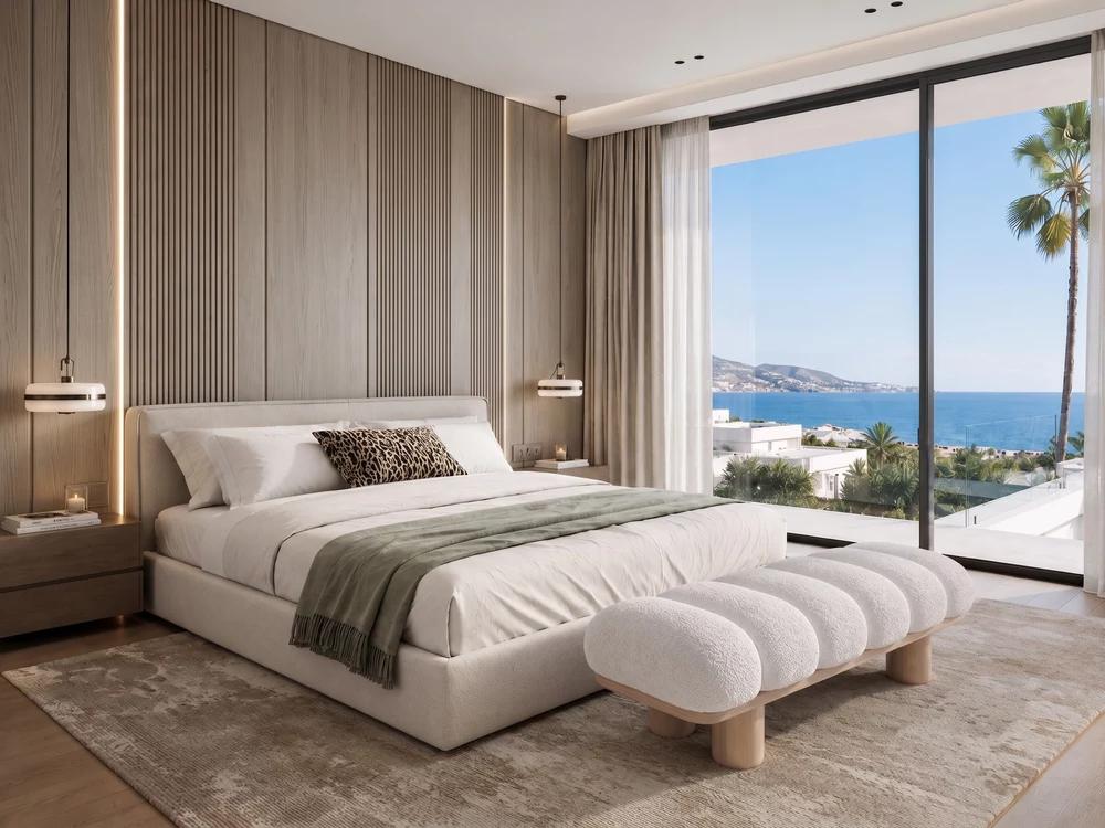 Modern coastal bedroom design with wood-paneled headboard wall, neutral bedding, and ocean view