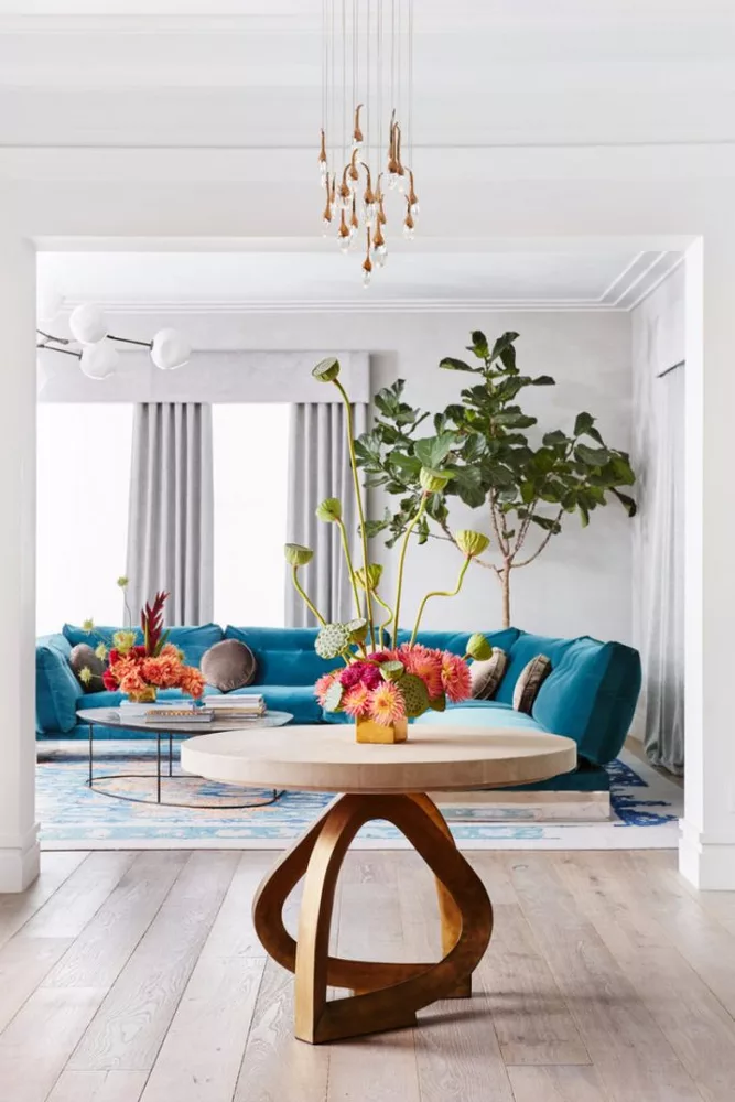 Bright living room in Culver City with blue sofa, natural light, and colorful accents