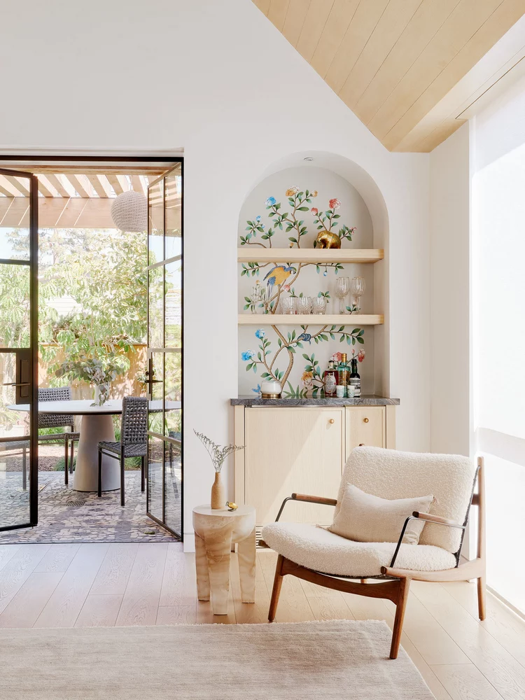 Bright living space with arched niche shelving and lounge chair