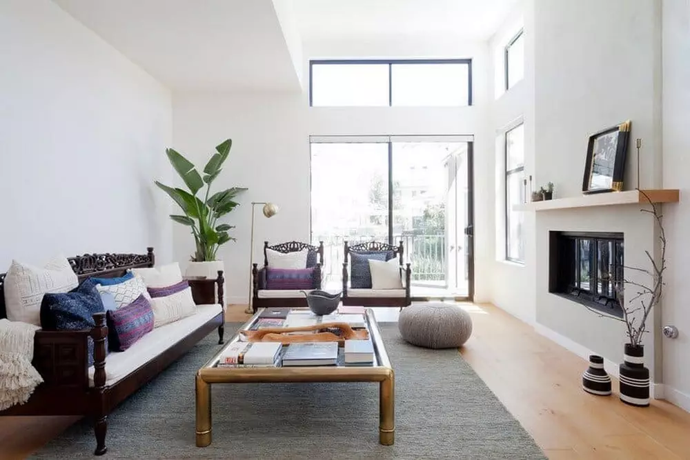 Bright living room with large windows, neutral tones, and modern coffee table