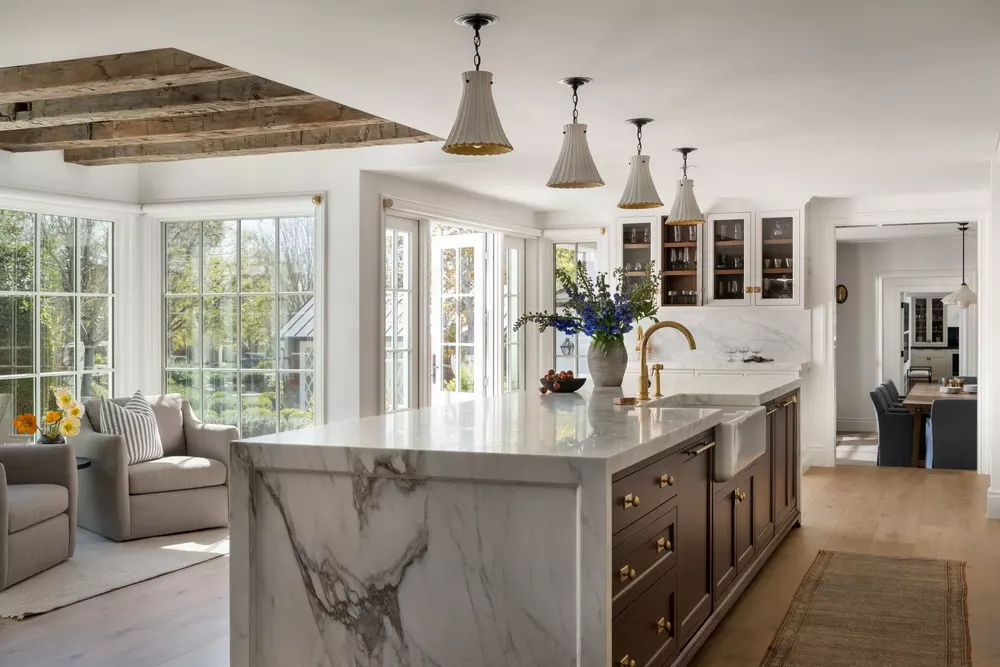 Modern Orange County kitchen with marble island, wood cabinetry, and natural light