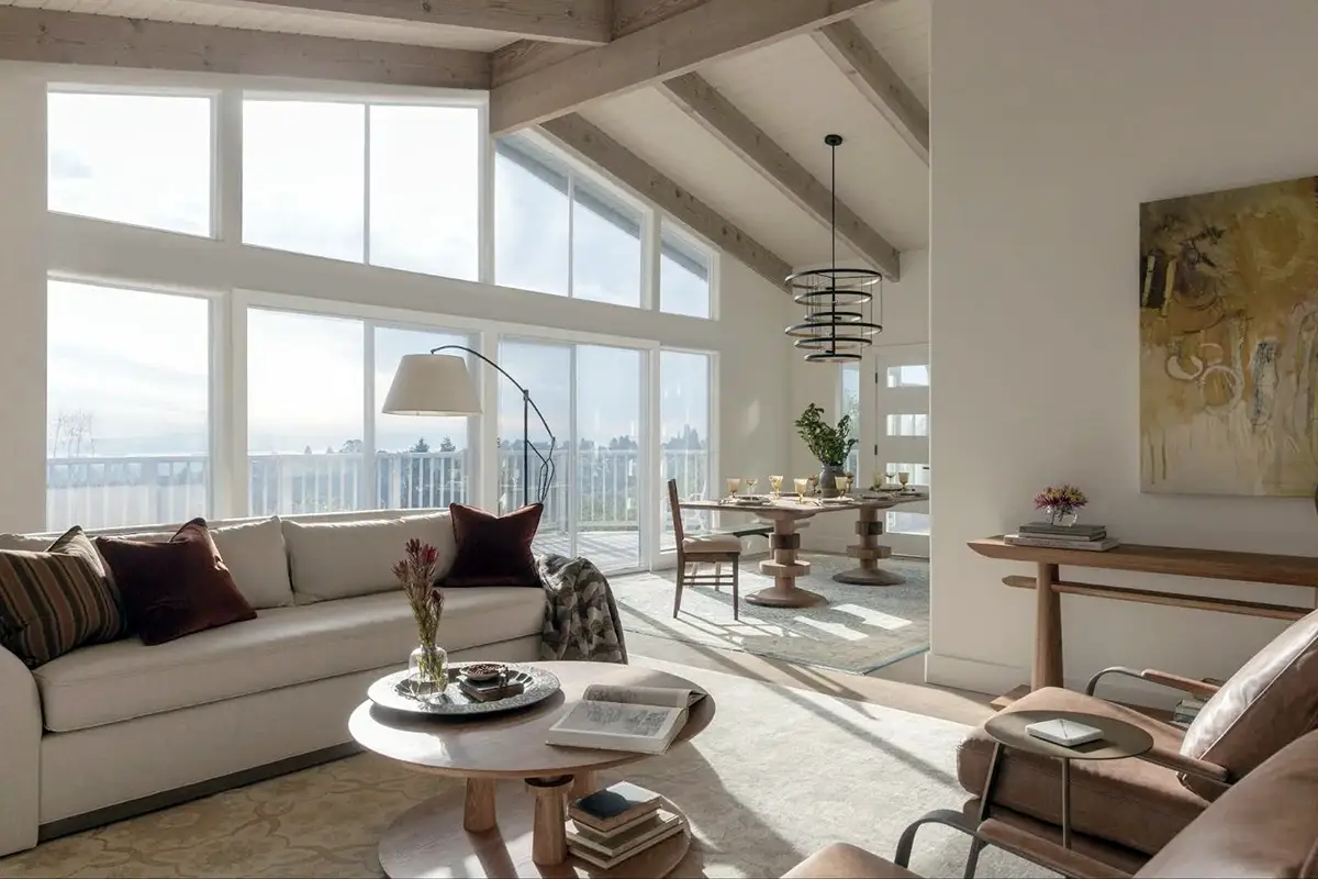bright modern living room with large windows, natural light, and open-plan layout.