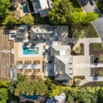 Aerial view of a California home with a pool and landscaped yard