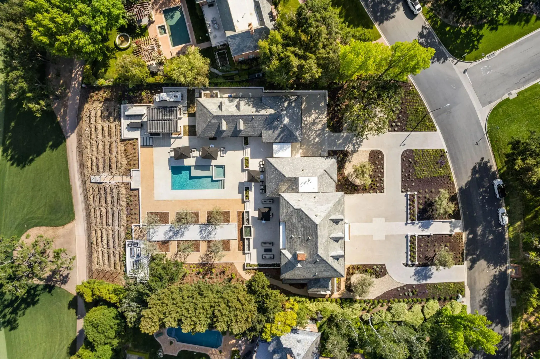 Aerial view of a California home with a pool and landscaped yard